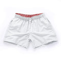 Men's polyester straight-leg surf shorts on a hanger, available in multiple solid colours.