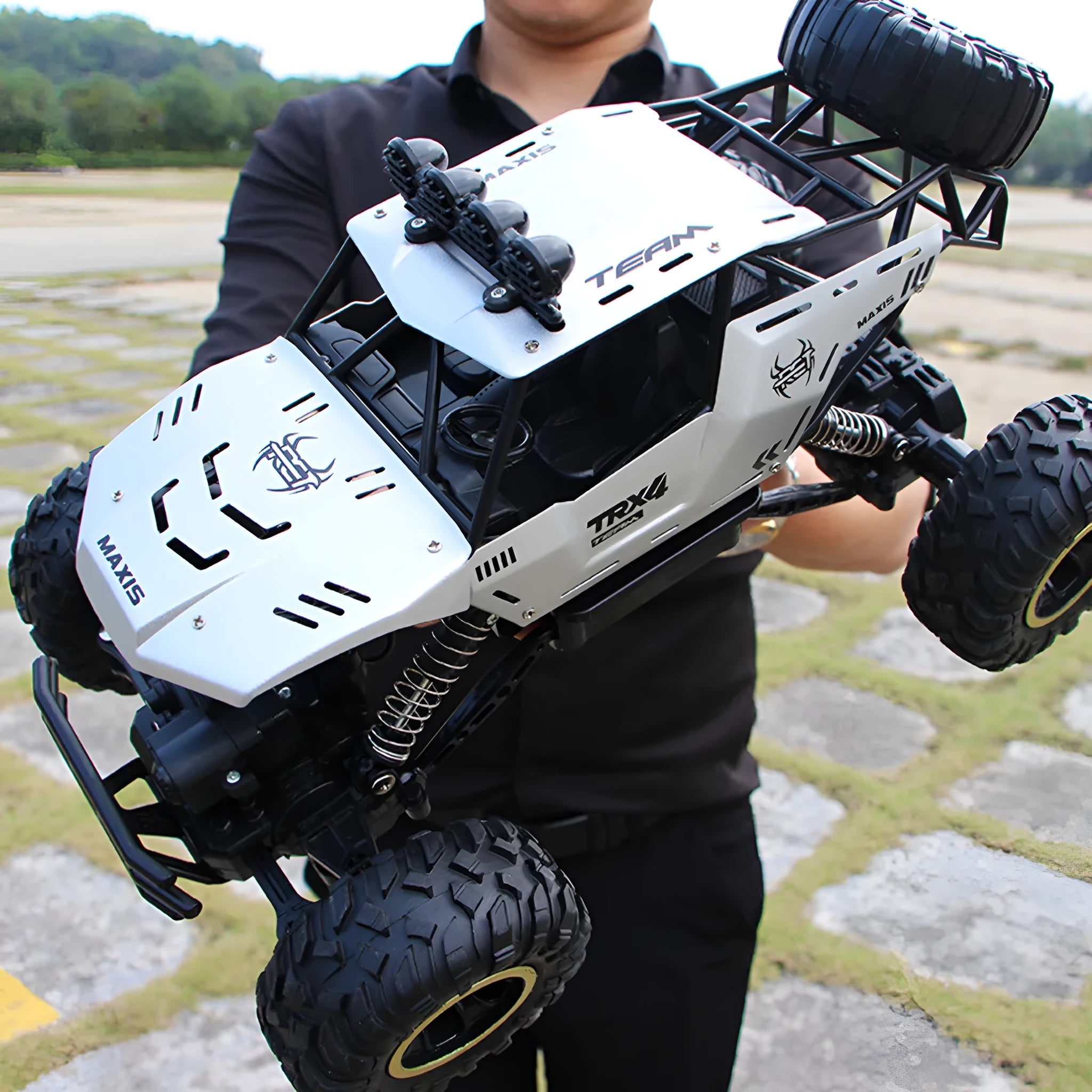 Large black 2.4G remote control four-wheel drive off-road climbing car on rough terrain