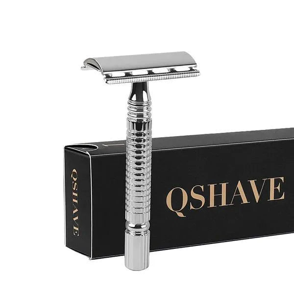 Chrome double edged safety razor with brass handle and closed comb head on storage box.