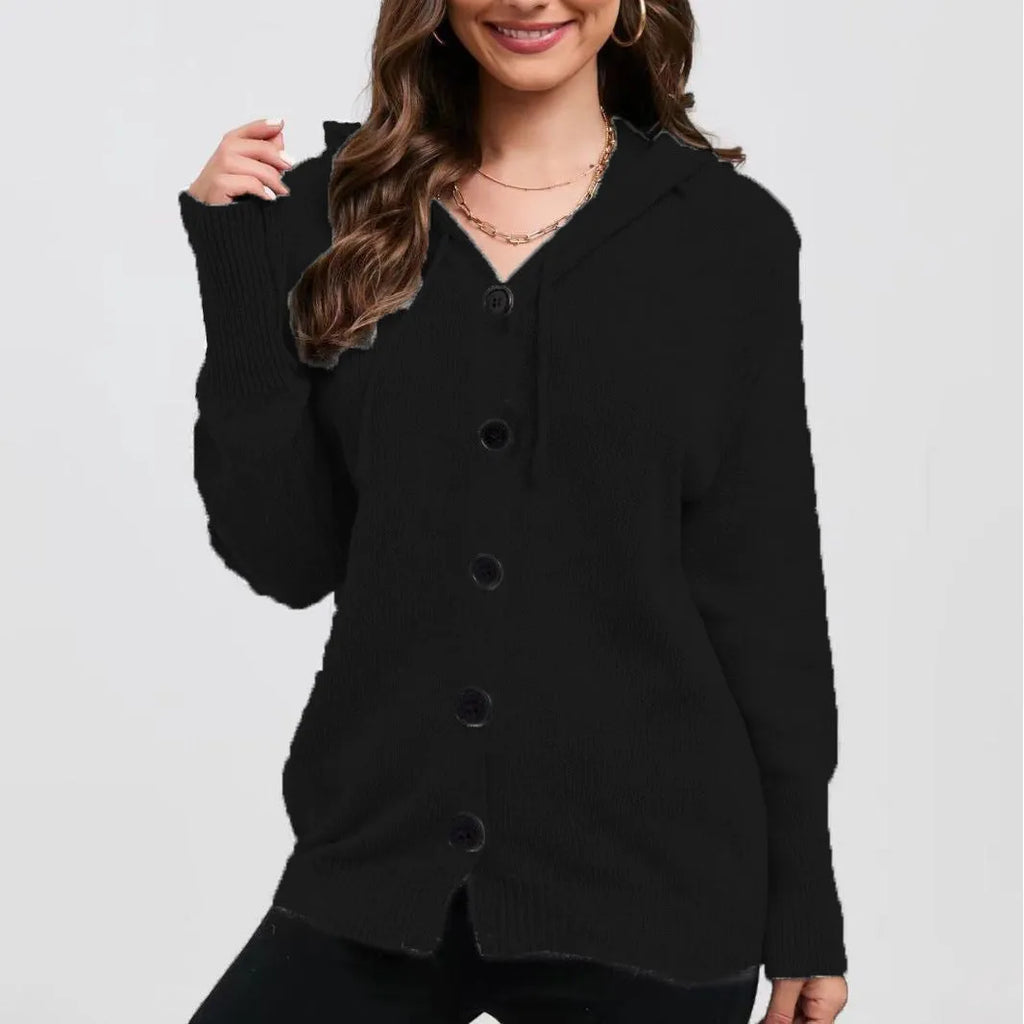 Woman wearing a thick, loose-fit hooded cardigan sweater in a solid colour.
