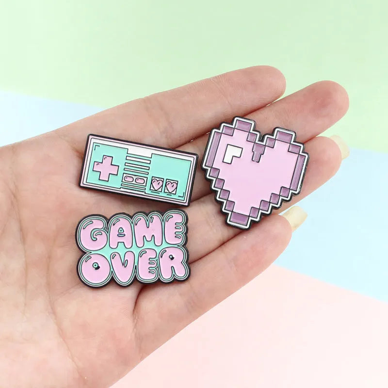 Stereo game console alloy pin badge in three colour options CC1122 CC1123 CC1124 on white background