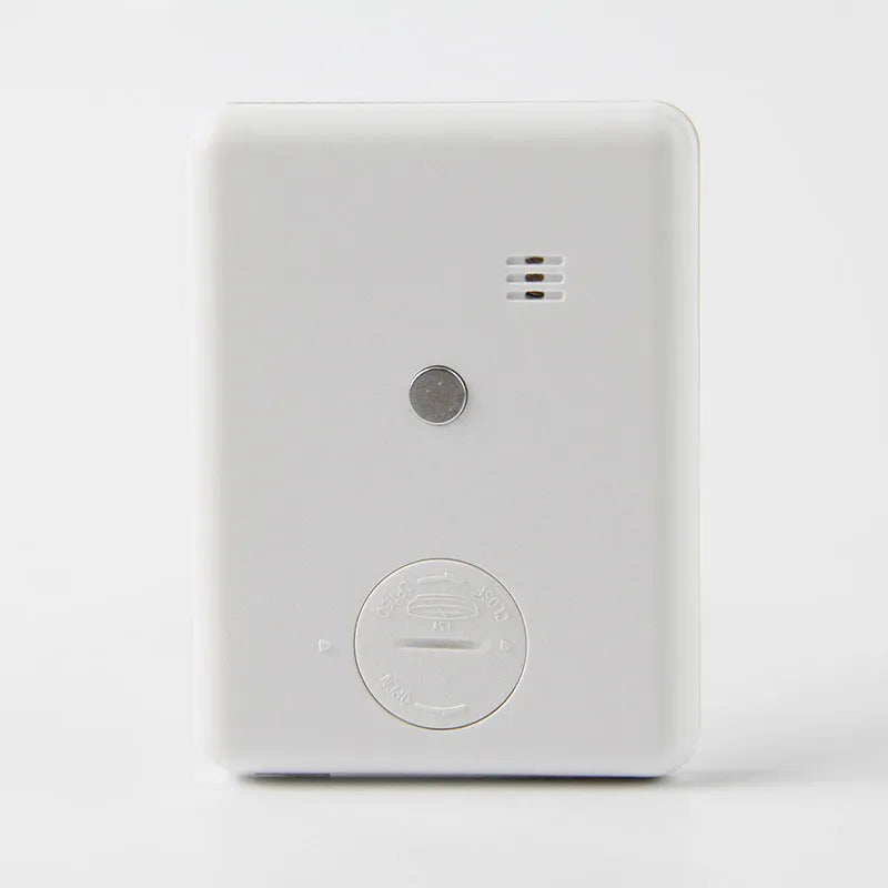 Square white digital kitchen timer with LCD display on magnetic refrigerator door