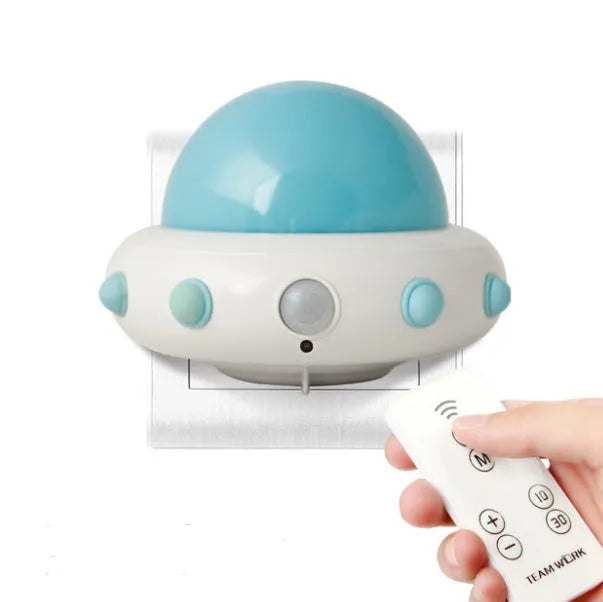 Remote control UFO-shaped bedside night light in blue, pink, or white colours.