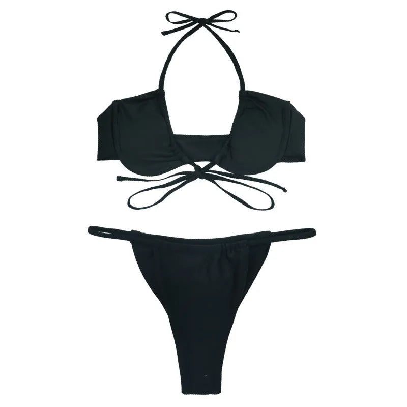 Black and mint green women's two-piece nylon bikini swimsuit on a hanger.