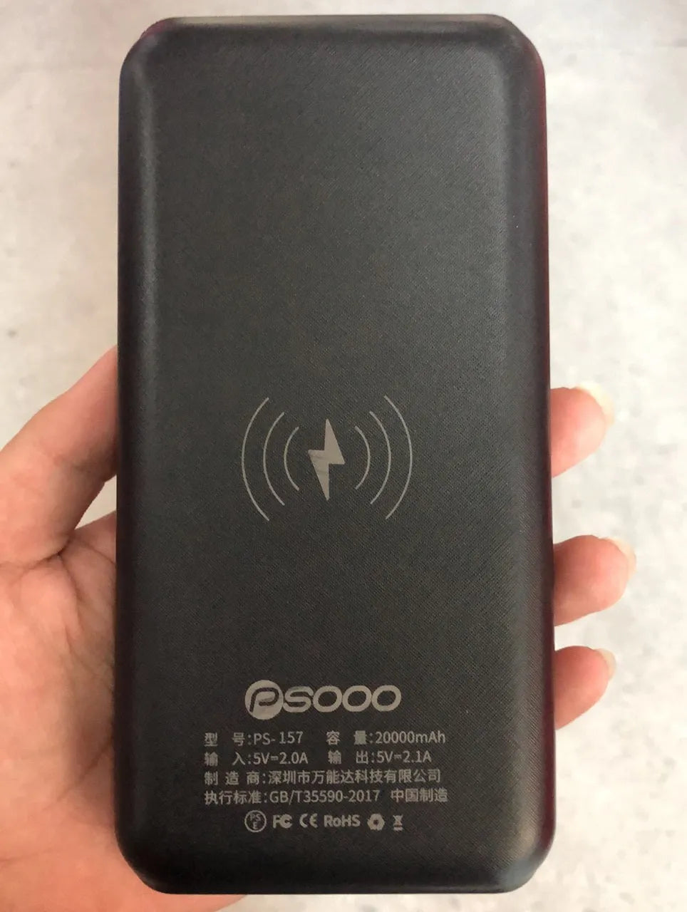 Portable solar power bank with Qi wireless charging and LED flashlight in black