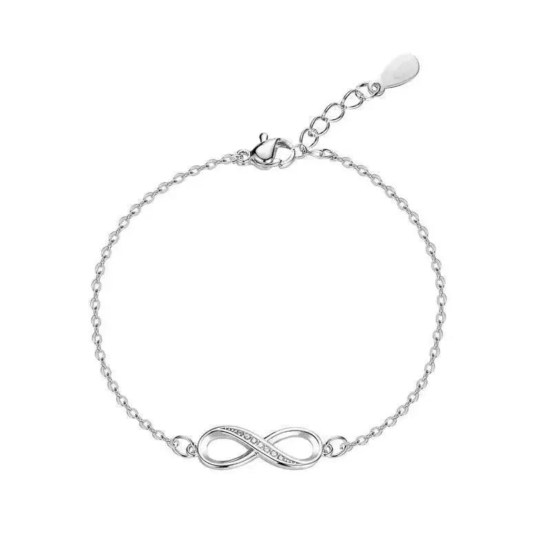 Silver copper Mobius strip diamond ring push-pull bracelet with lucky cat charm on display.