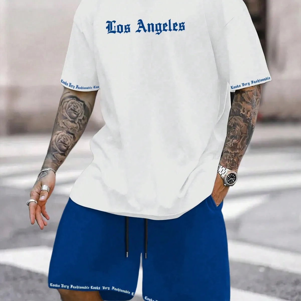 Men's navy blue printed short-sleeved top and matching shorts sports set on a white background