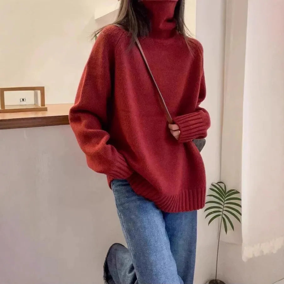Women's loose turtleneck sweater with thick curling pile collar in red, camel, grey, or black.