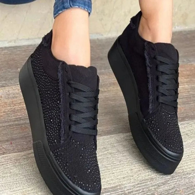 Women's black lace-up casual sports shoes with rhinestone detail on the side and a chunky rubber sole.