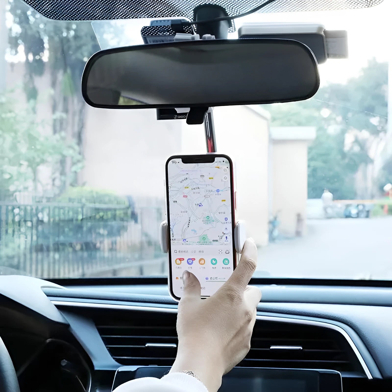 Black ABS plastic mobile phone bracket mounted on a car rearview mirror holding a smartphone