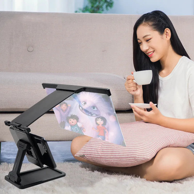 Black L20 mobile phone screen magnifier with foldable bracket and hard travel case on a table.