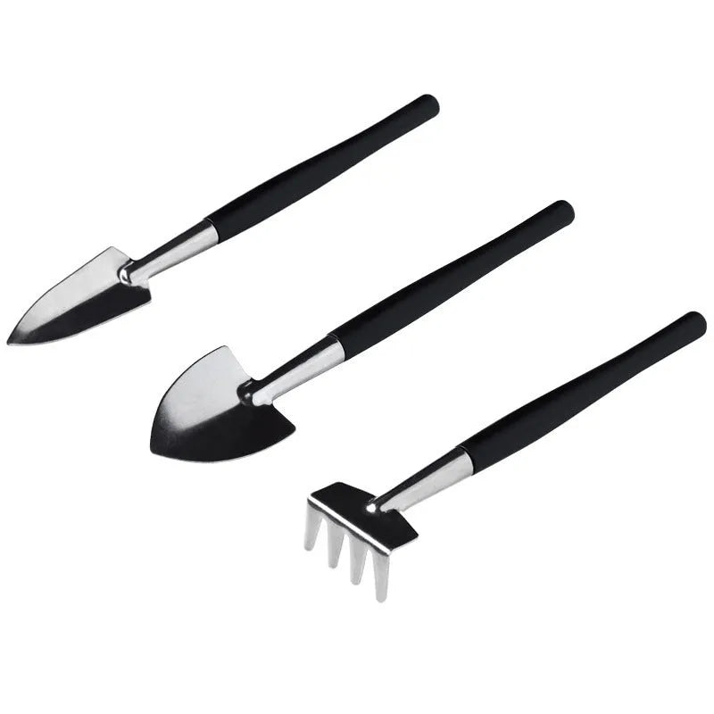 15-piece black mini garden hand tool set for succulent and bonsai plants on a grey cushion.