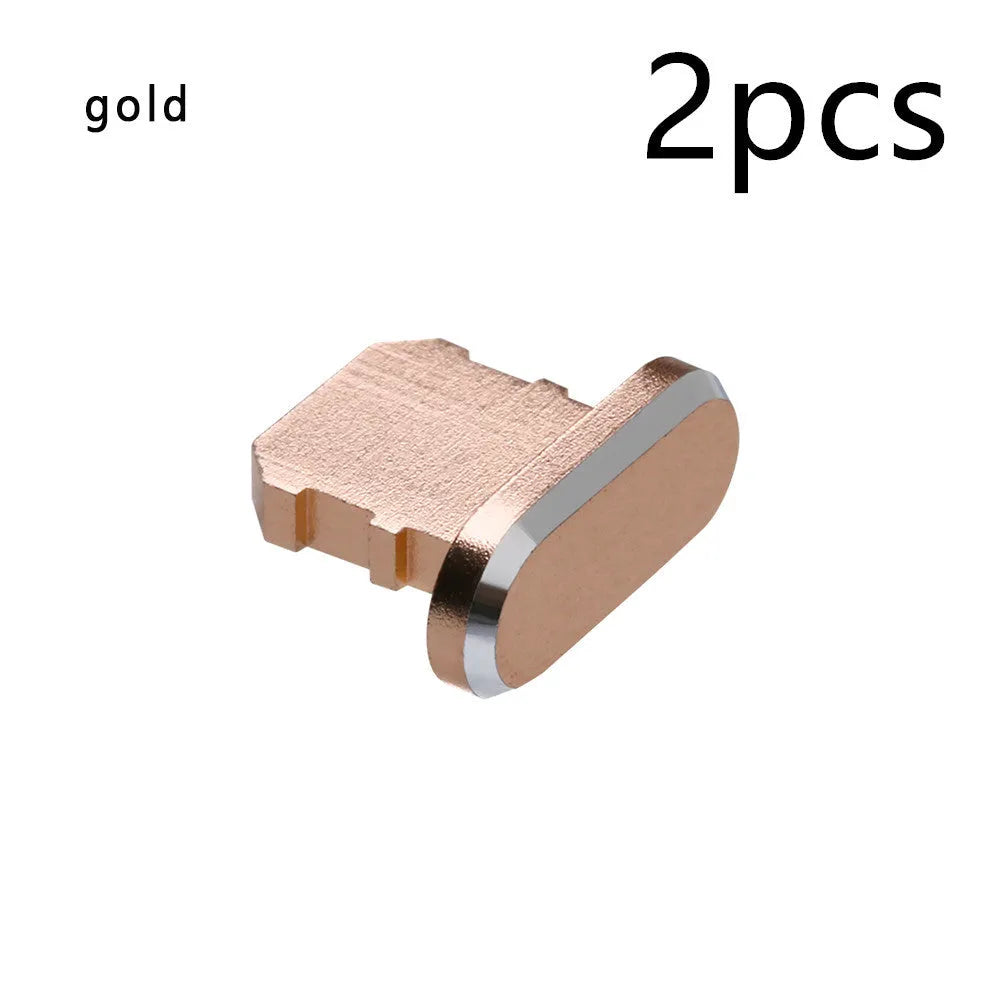 Aluminium alloy iPhone charging port dust plug in rose gold colour next to an iPhone.