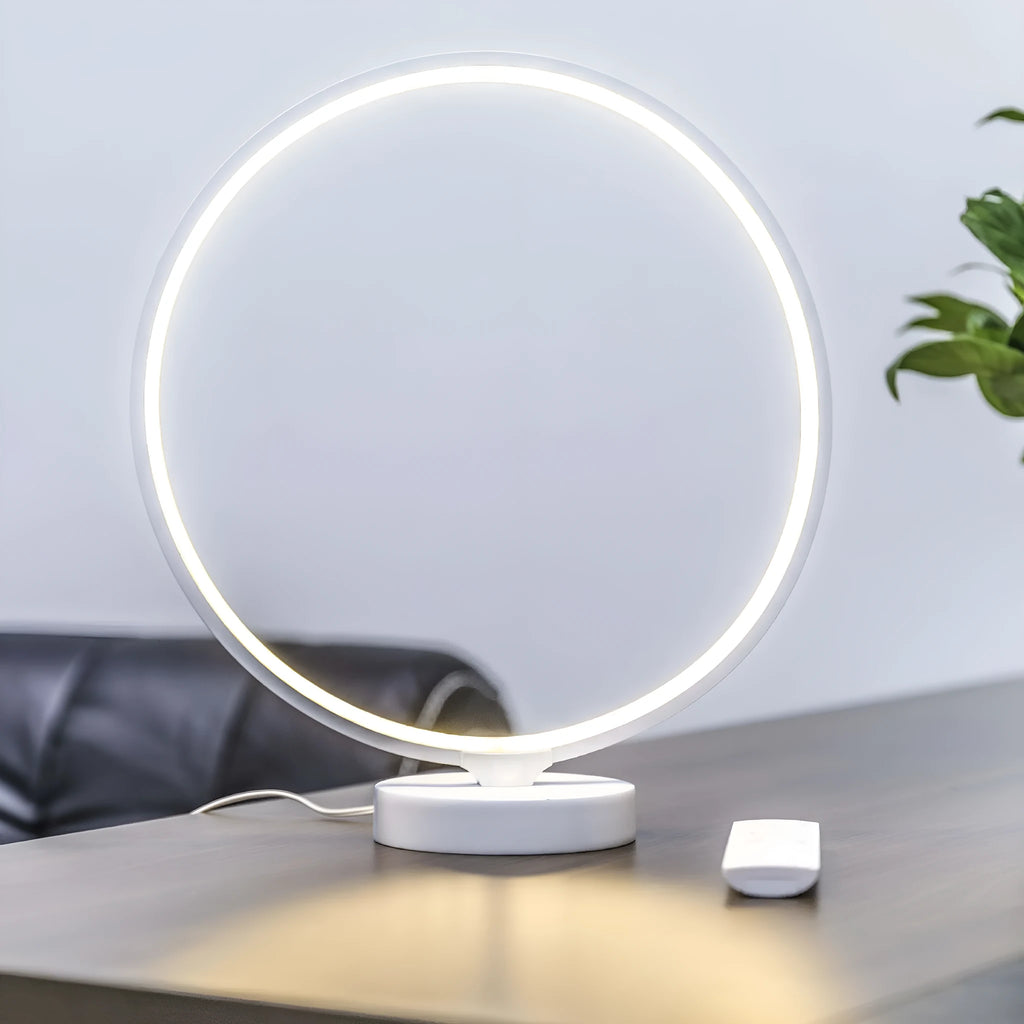 White Full Moon mood lamp with remote control on a table.