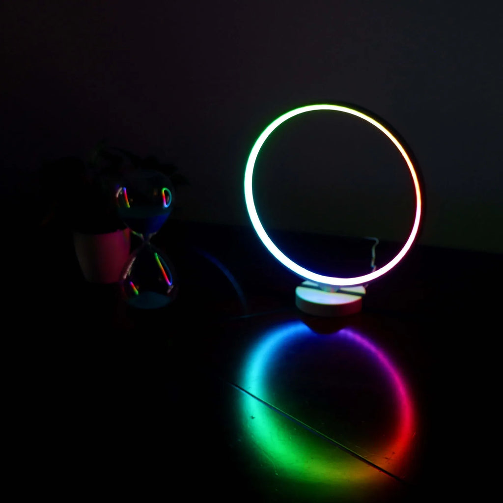 White Full Moon mood lamp with remote control on a table.