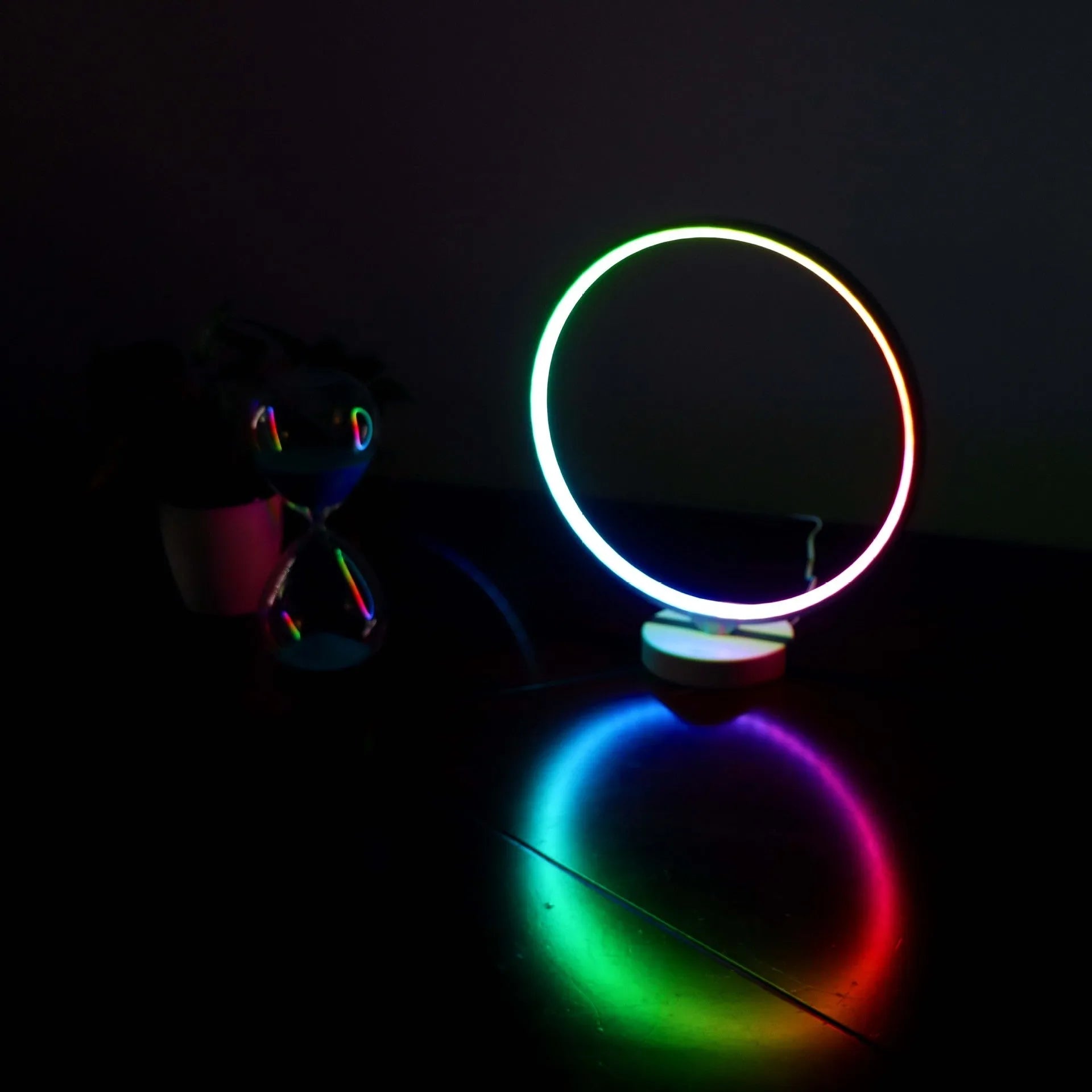 White Full Moon mood lamp with remote control on a table.