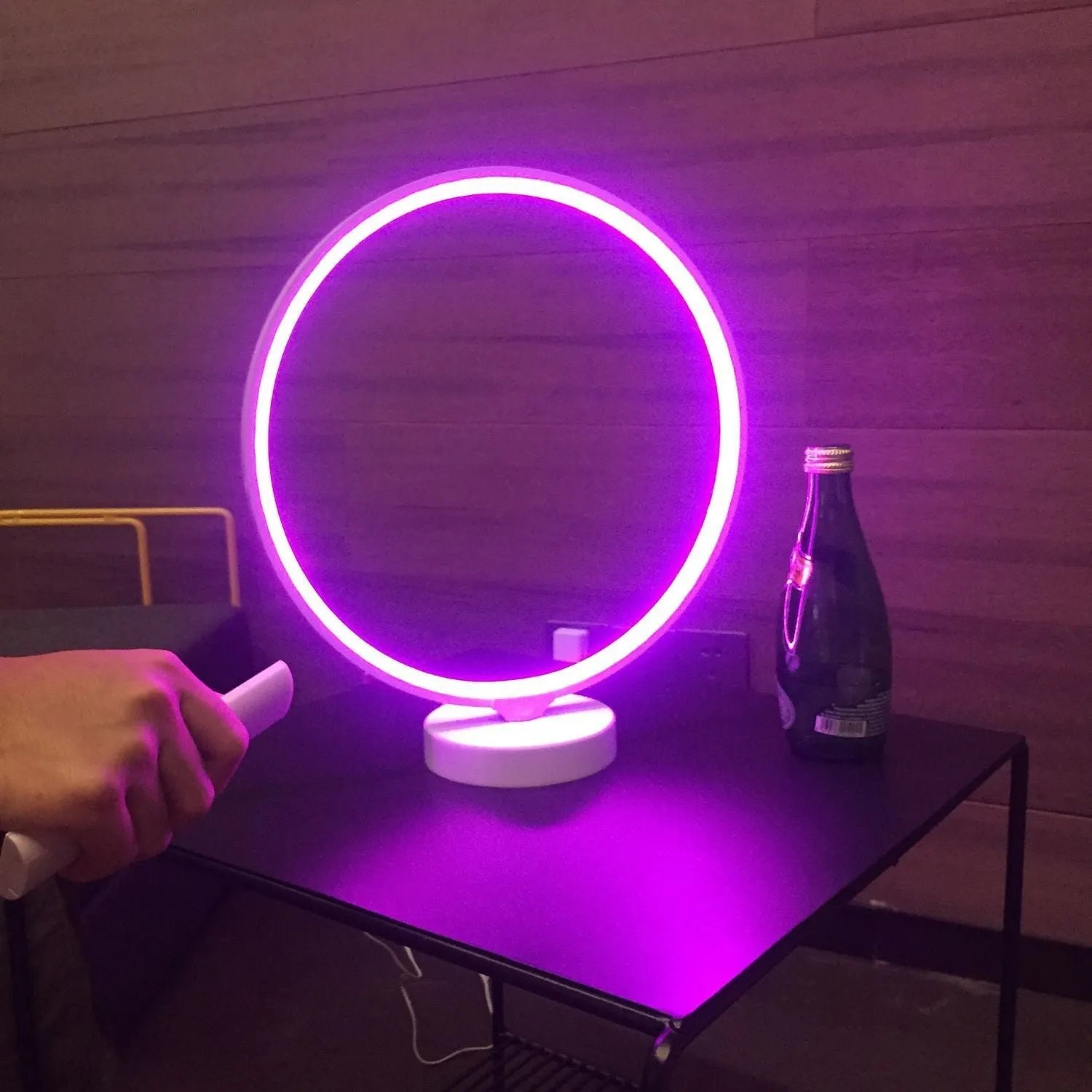 White Full Moon mood lamp with remote control on a table.
