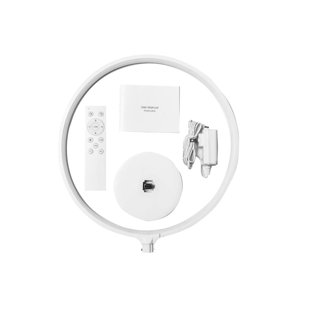White Full Moon mood lamp with remote control on a table.