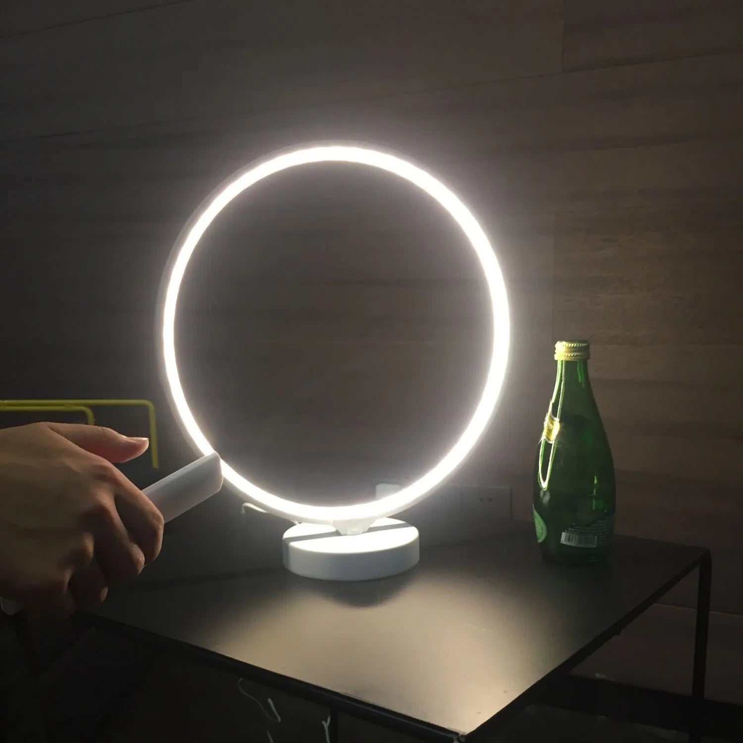 White Full Moon mood lamp with remote control on a table.
