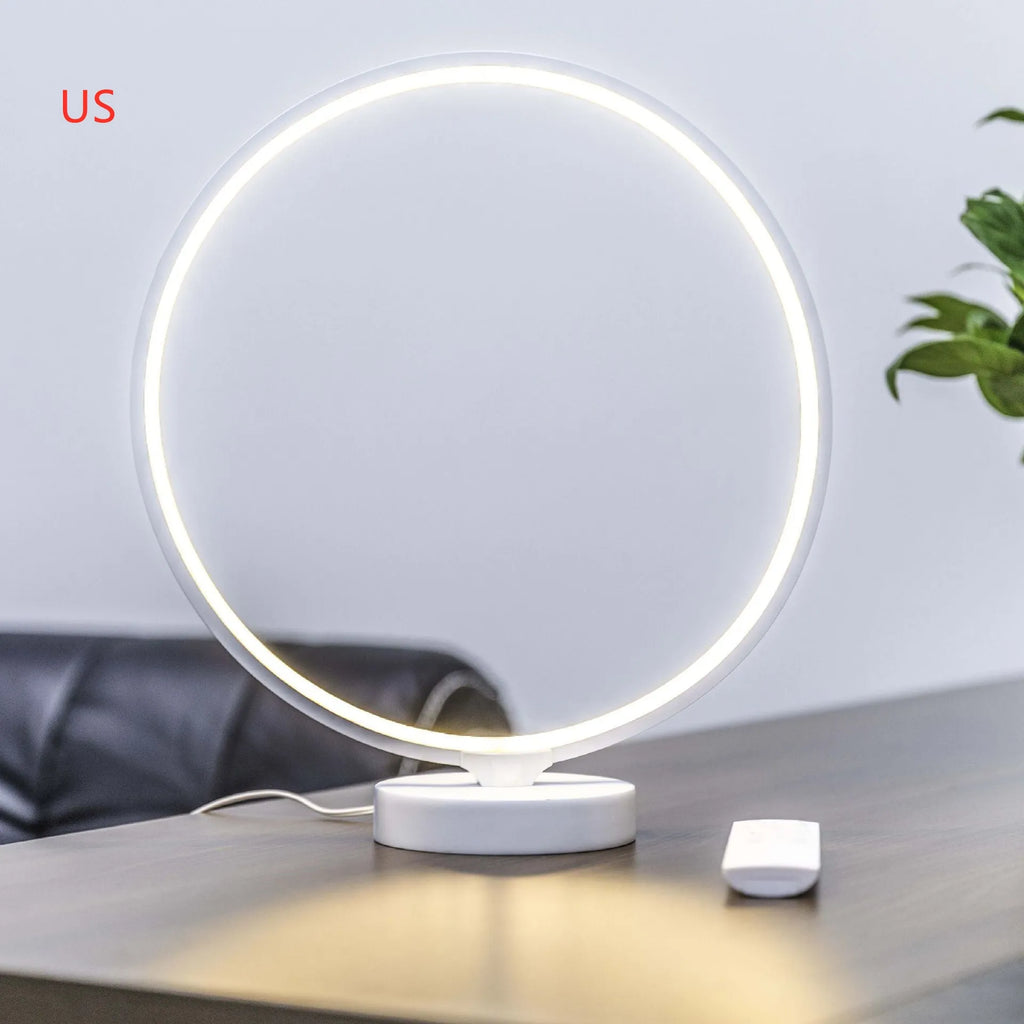 White Full Moon mood lamp with remote control on a table.
