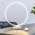 White Full Moon mood lamp with remote control on a table.