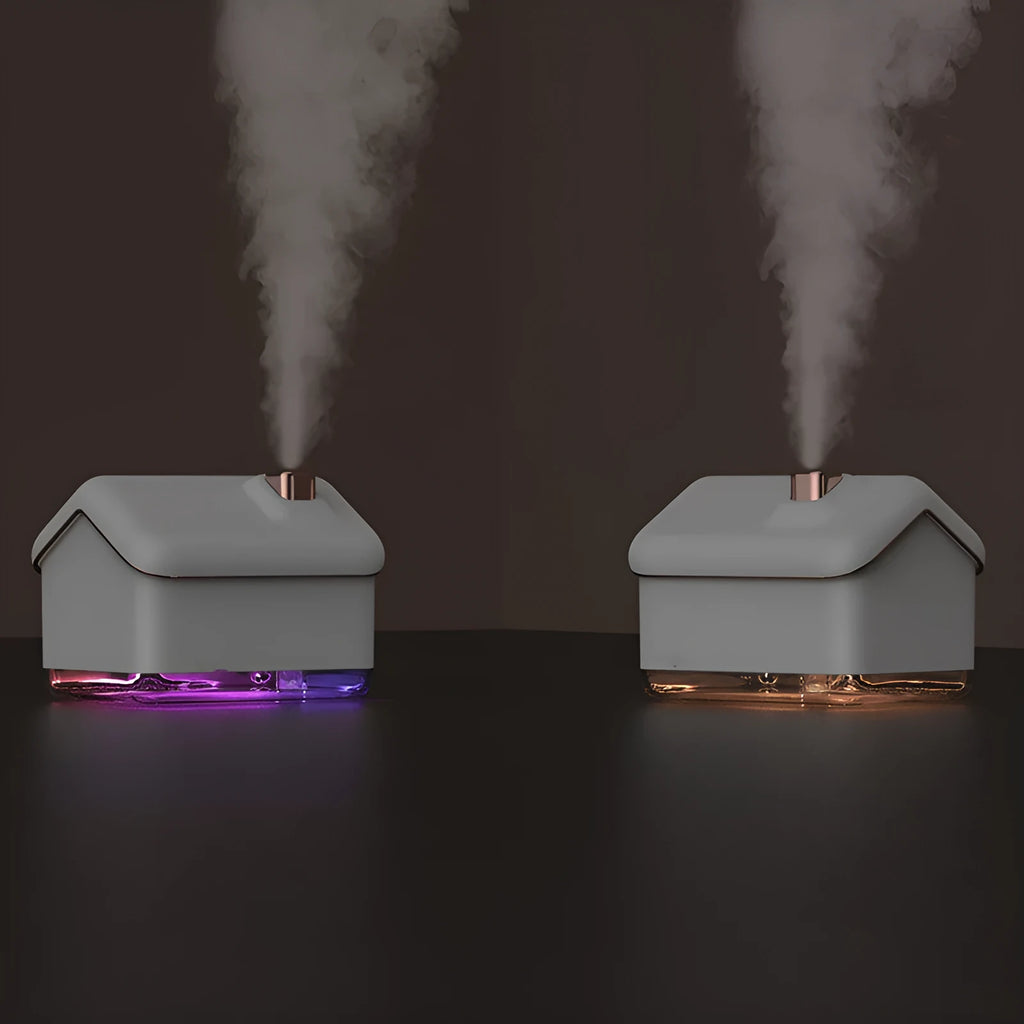 White Igloo-shaped ultrasonic humidifier and essential oil diffuser with LED light on a wooden table.