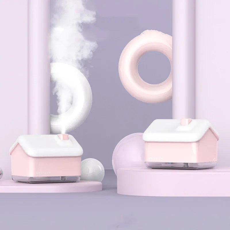 White Igloo-shaped ultrasonic humidifier and essential oil diffuser with LED light on a wooden table.