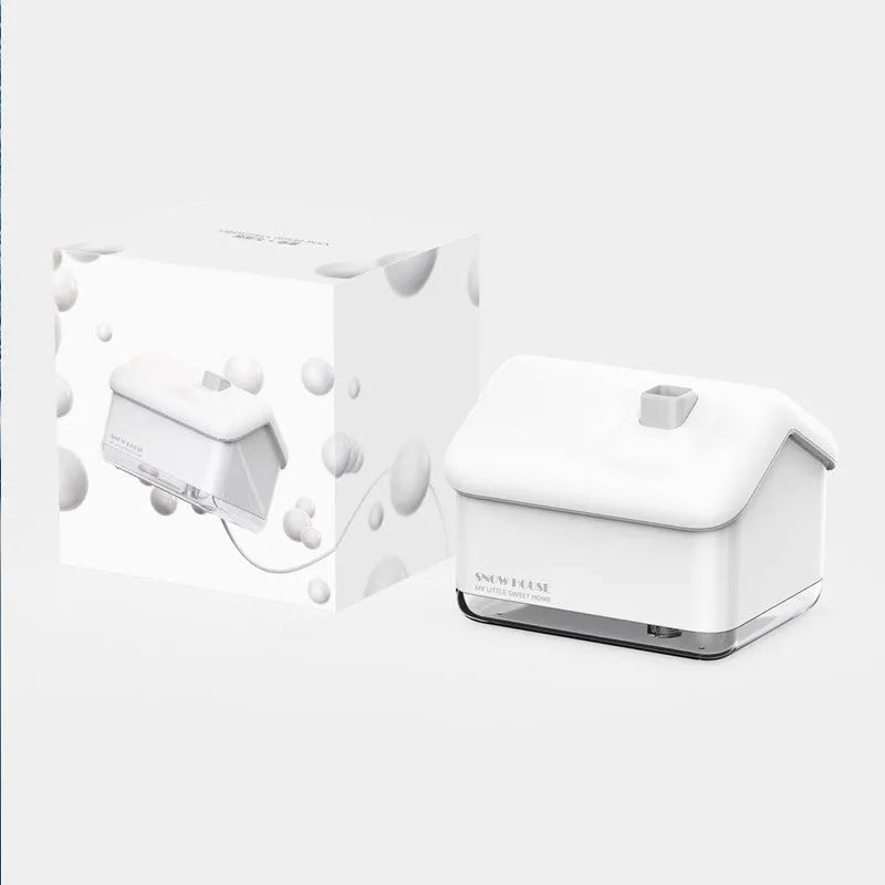 White Igloo-shaped ultrasonic humidifier and essential oil diffuser with LED light on a wooden table.
