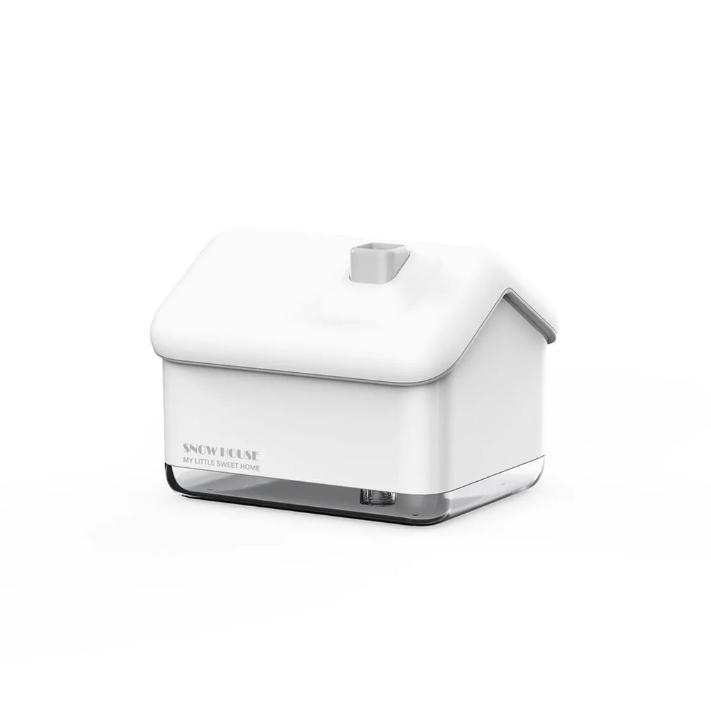 White Igloo-shaped ultrasonic humidifier and essential oil diffuser with LED light on a wooden table.