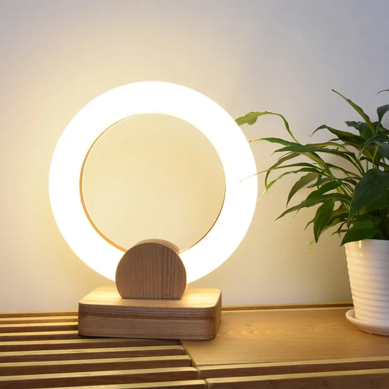 Nordic style circular wooden art chandelier with acrylic shade hanging from a ceiling.