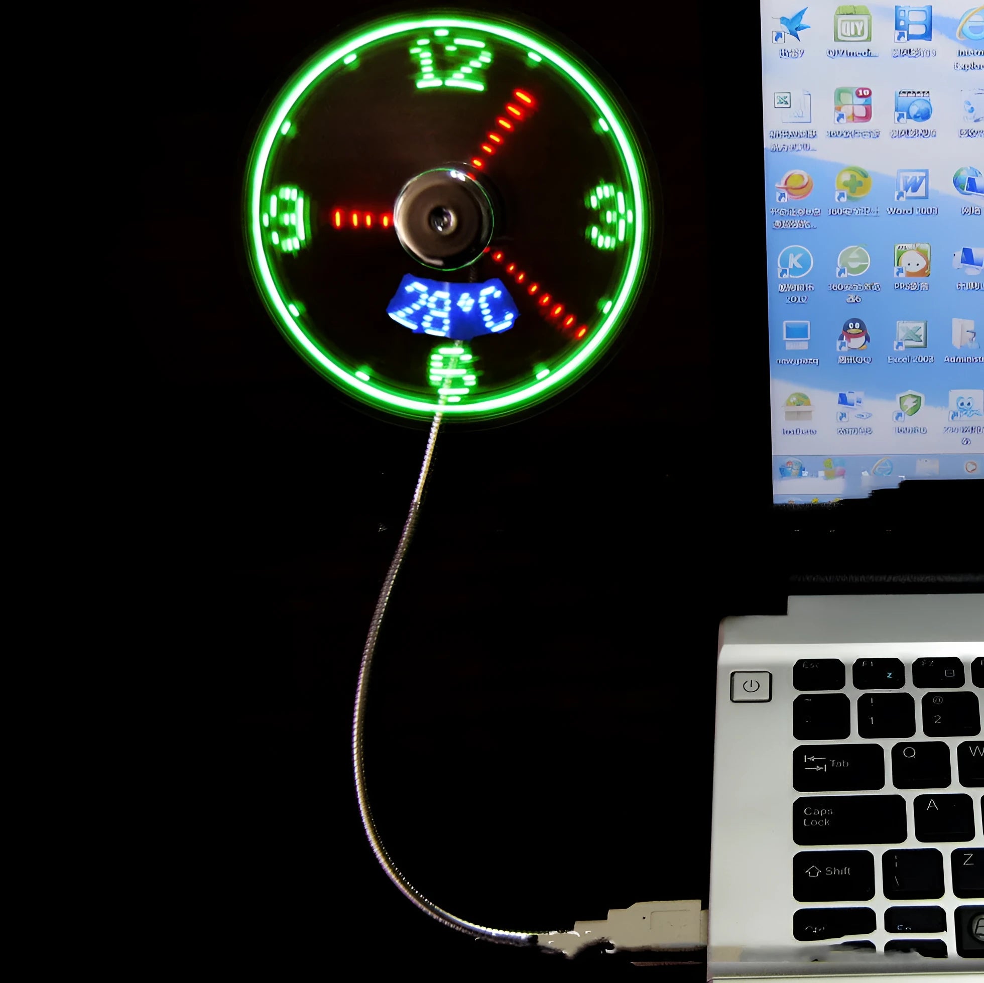 Silver USB clock temperature fan with LED display, soft plastic blades, and flexible metal neck on a desk