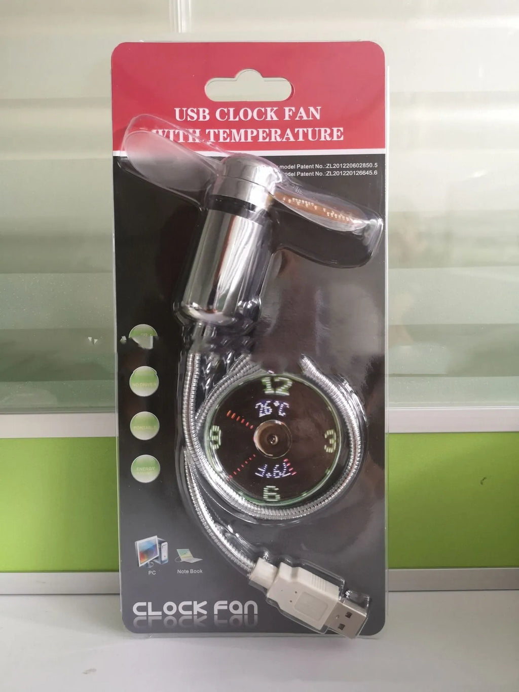 Silver USB clock temperature fan with LED display, soft plastic blades, and flexible metal neck on a desk