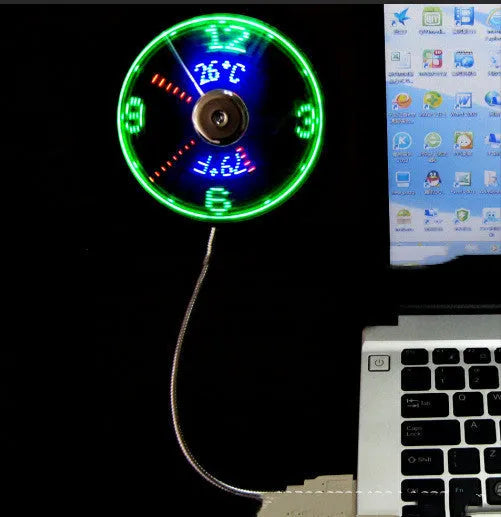 Silver USB clock temperature fan with LED display, soft plastic blades, and flexible metal neck on a desk