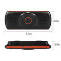Orange plastic Bluetooth hands-free car kit mounted on a sun visor.