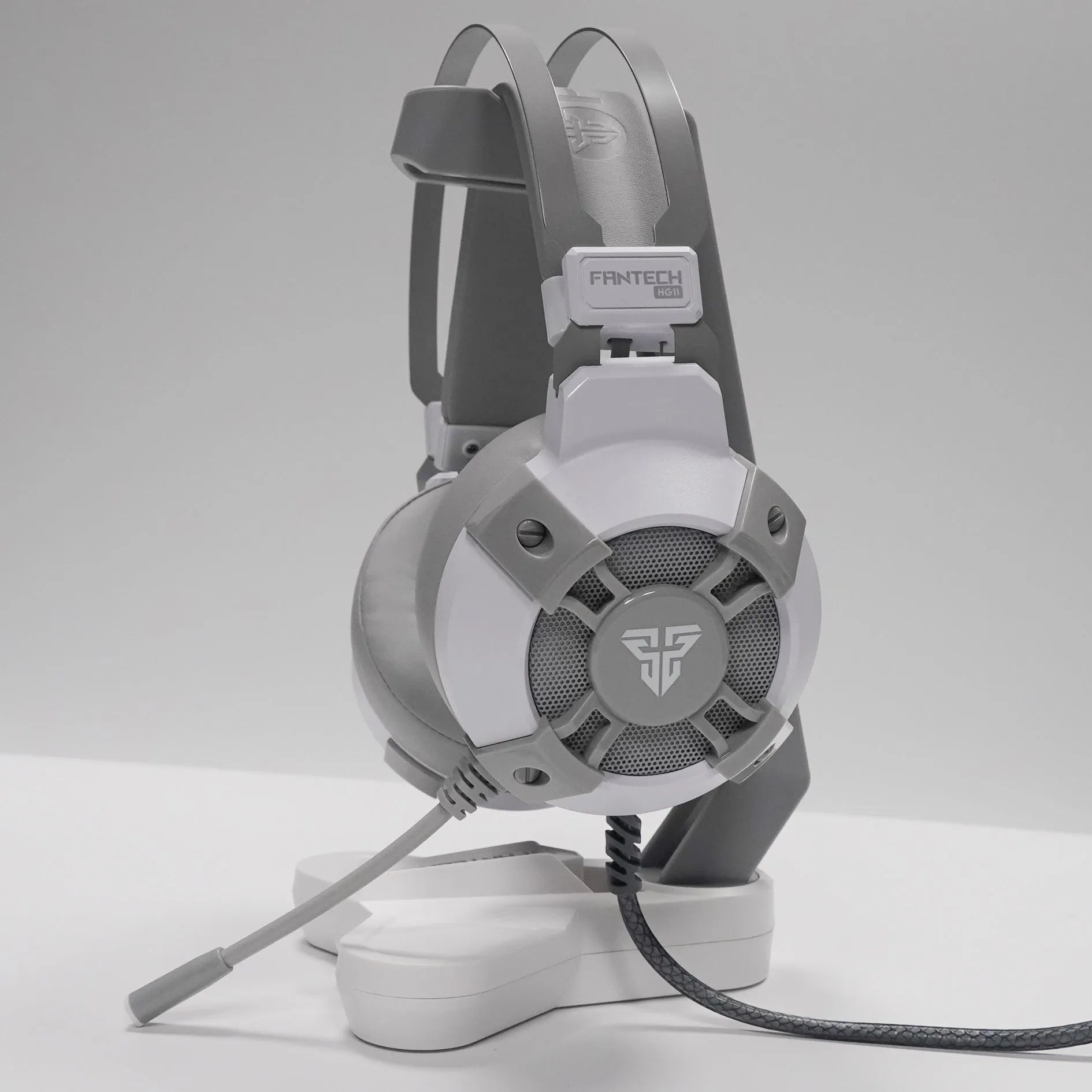 Black FANTECH HG11 gaming headset with RGB lights on ear cups and a USB cable.