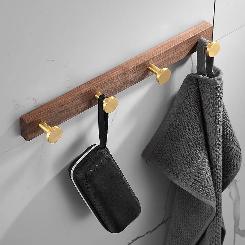 Black walnut aluminium clothes hooks with brass wire drawing finish on a bathroom wall