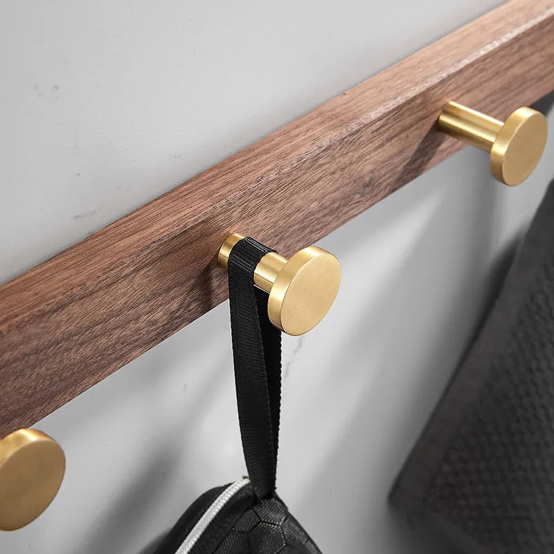Black walnut aluminium clothes hooks with brass wire drawing finish on a bathroom wall
