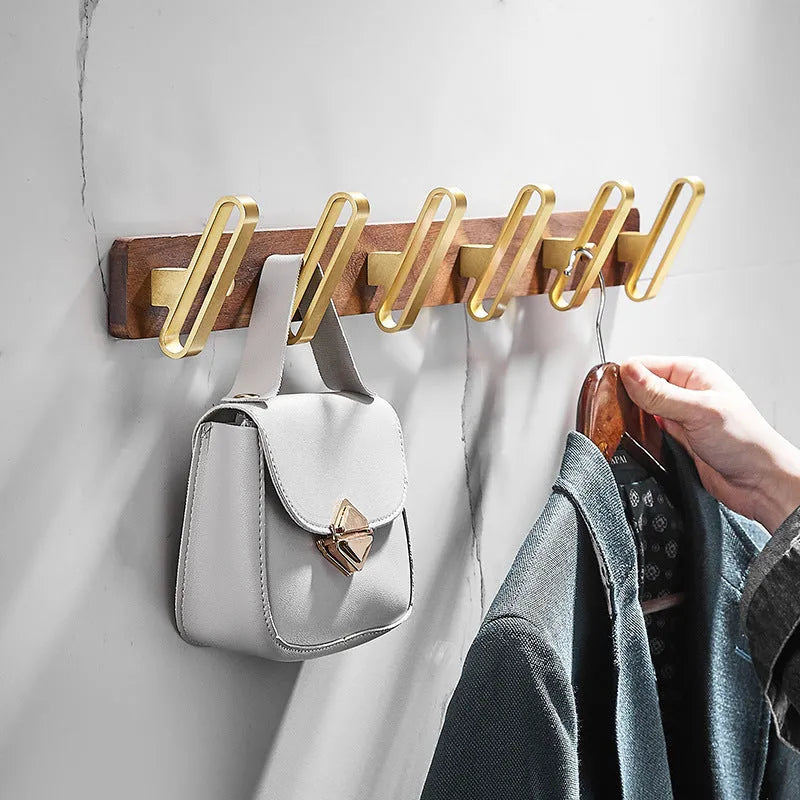 Black walnut aluminium clothes hooks with brass wire drawing finish on a bathroom wall
