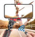 Black aluminium video stabiliser tripod extended with a mobile phone secured in the clamp.