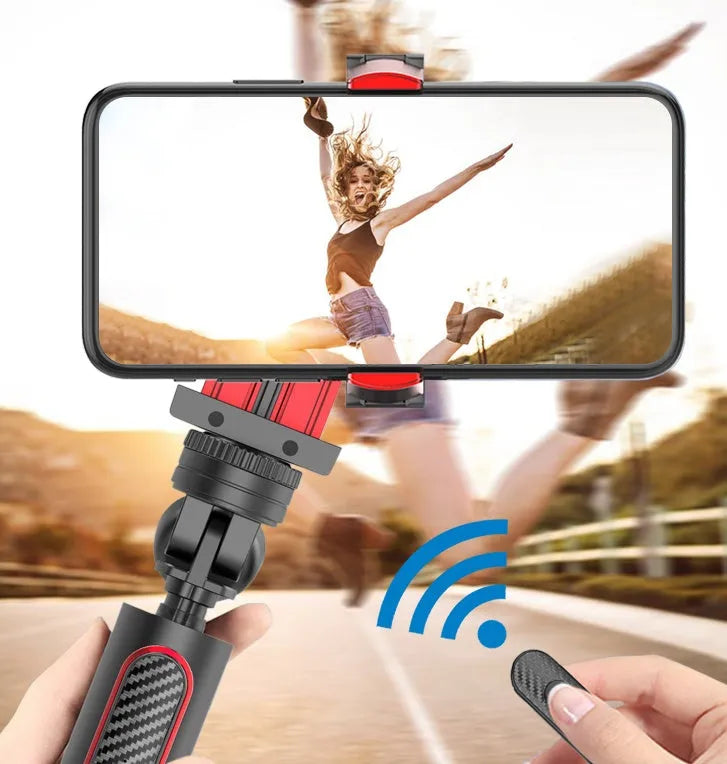 Black aluminium video stabiliser tripod extended with a mobile phone secured in the clamp.