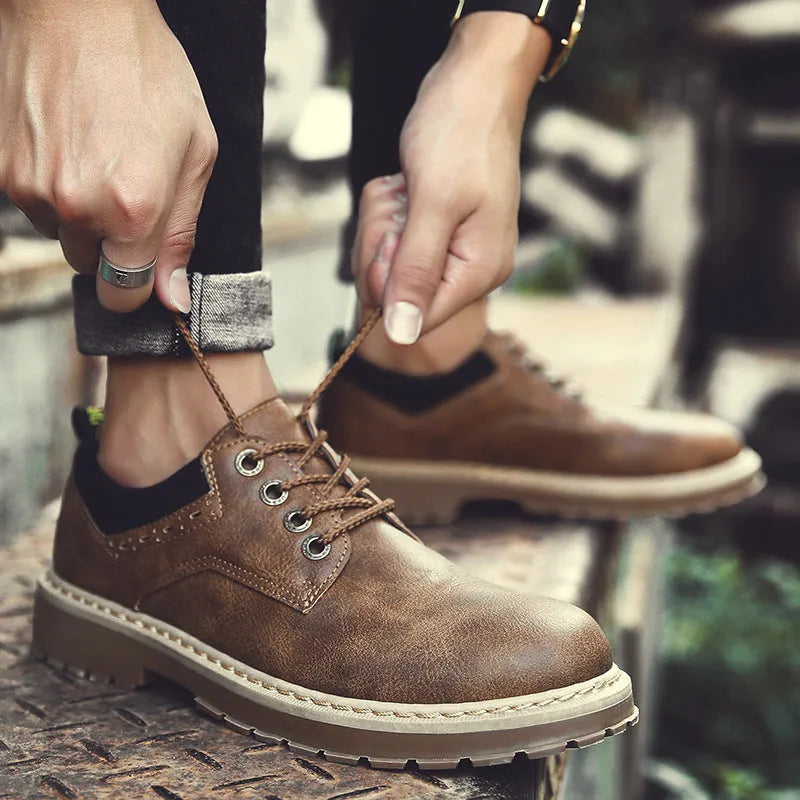 Men's black casual lace-up shoes with a round toe and low-cut design on a rubber sole.