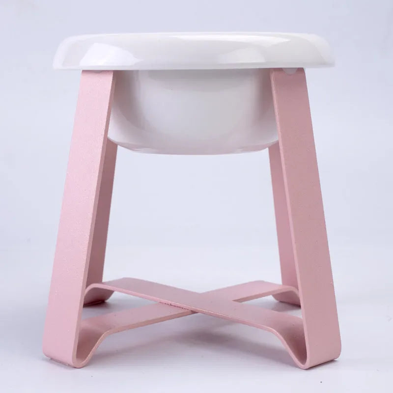 Elevated ceramic cat feeding bowl with gold iron stand and stainless steel surface in pink colour