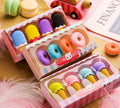 Set of 12 cartoon erasers with ice cream, donut, lollipop, and cone designs for children.
