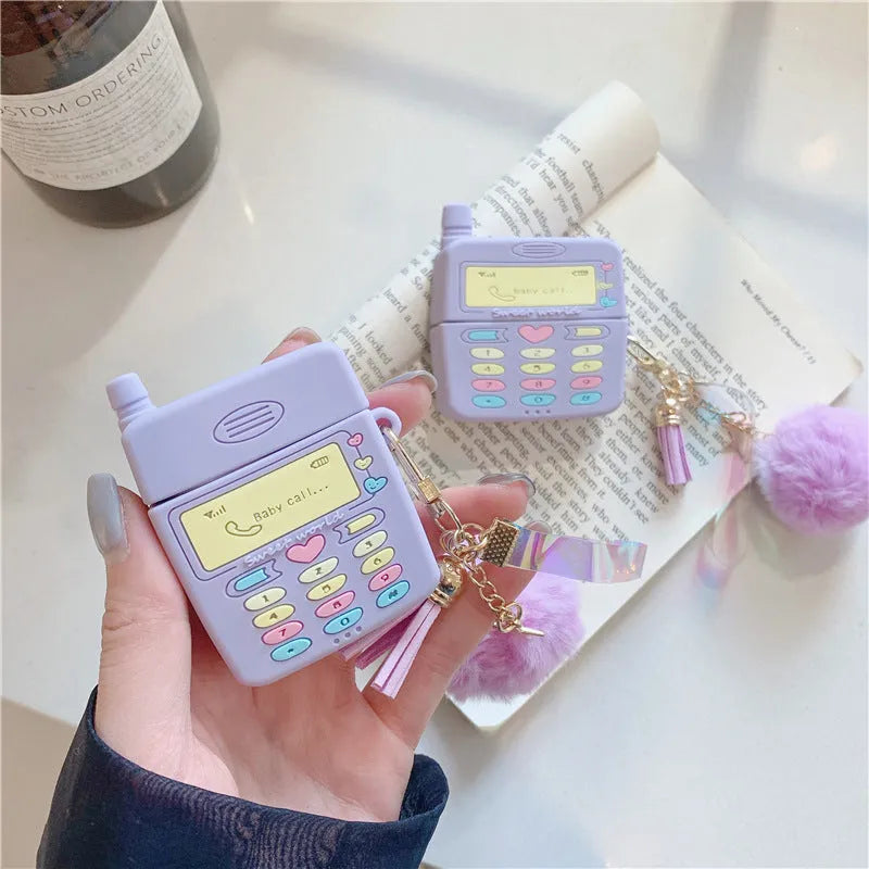 Purple silicone protective case for Apple AirPods with a small furry purple pendant attached.