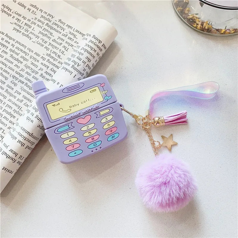 Purple silicone protective case for Apple AirPods with a small furry purple pendant attached.