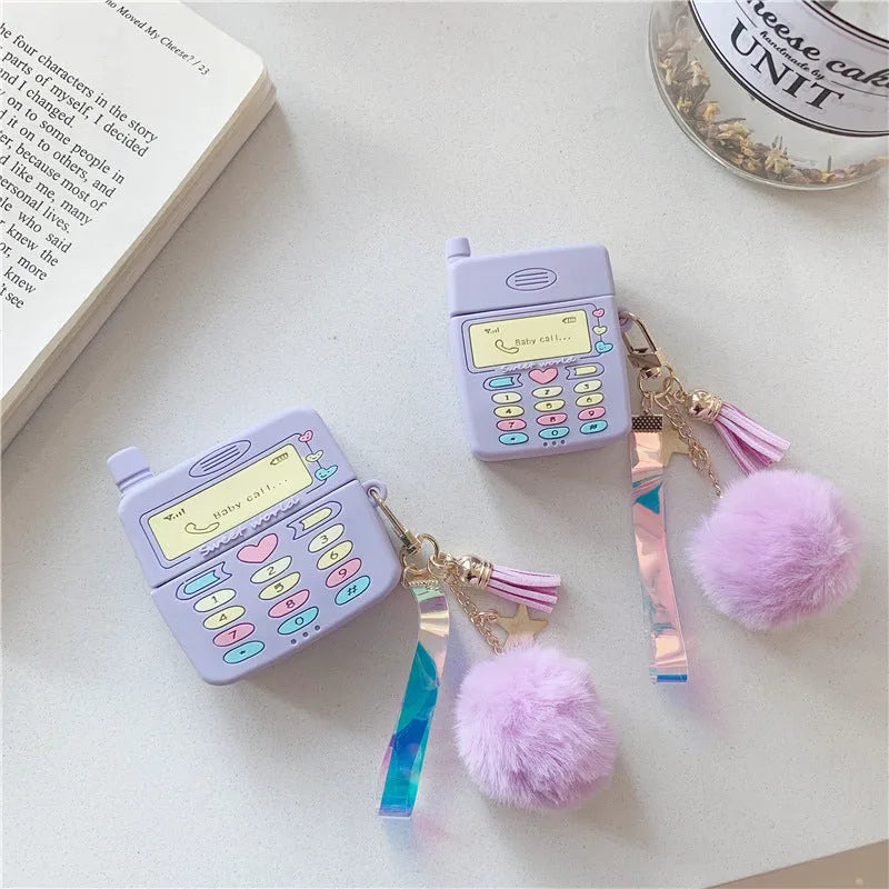 Purple silicone protective case for Apple AirPods with a small furry purple pendant attached.