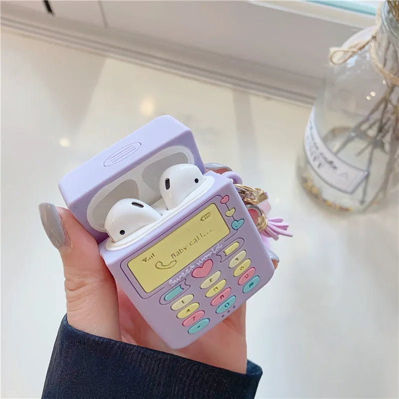 Purple silicone protective case for Apple AirPods with a small furry purple pendant attached.