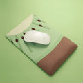 A soft gel-filled wrist mouse pad with a cute printed design on a cloth surface.