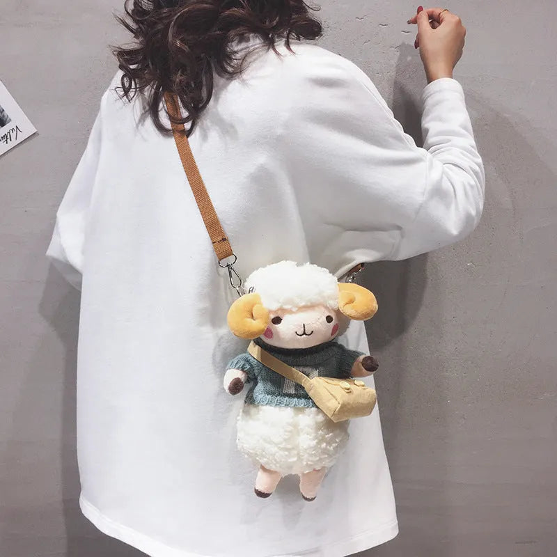 Little Sheep plush crossbody bag in blue with lamb pattern, showing small square shape and soft handle