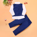 Blue boys smart clothing set with turtleneck, waistcoat, tie, and trousers on a hanger